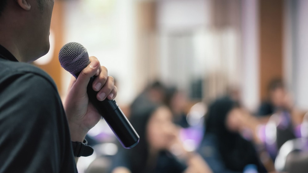 Man giving a speech to a class - an informative lecture - one of the types of public speaking