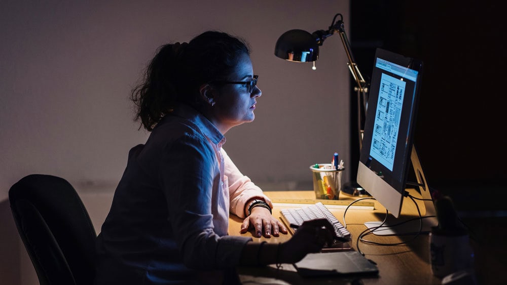 employee working late at night to learn new things and advance her career growth