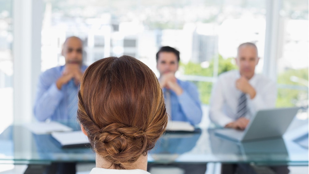 woman taking part in an interview panel stressing on need of business communication