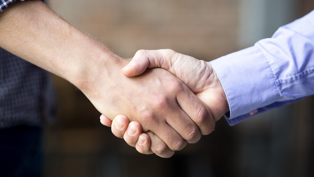 handshake between salesperson and client